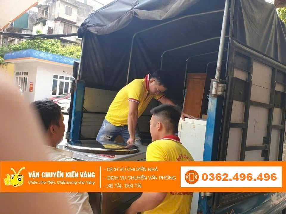 A modern, well-maintained moving truck with a company logo driving through a clean, tree-lined street in Hanoi, symbolizing efficient transportation. Blue skies, daytime, realistic.